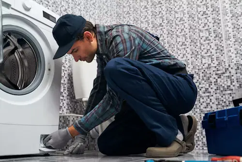 Technician repairing washing machine